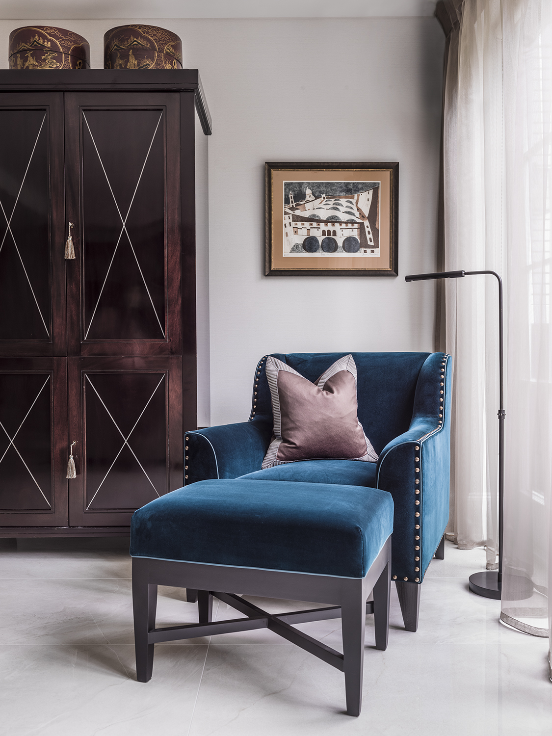 Blue chair with a light purple cushion with a photo frame behind